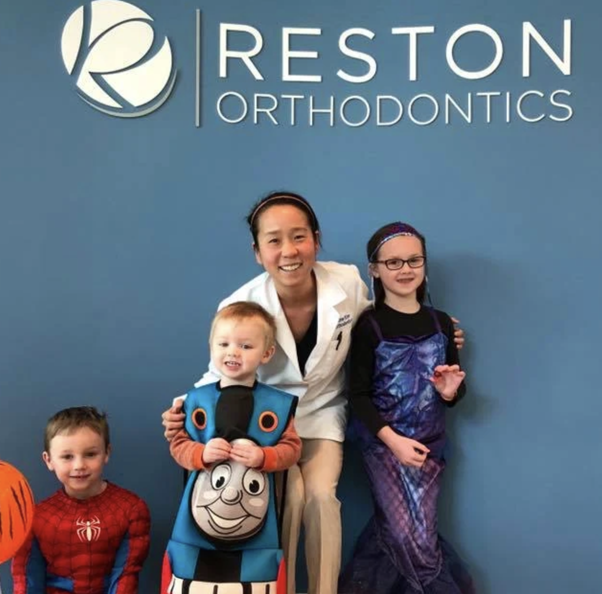 Dr. Kim with young patients dressed in costumes