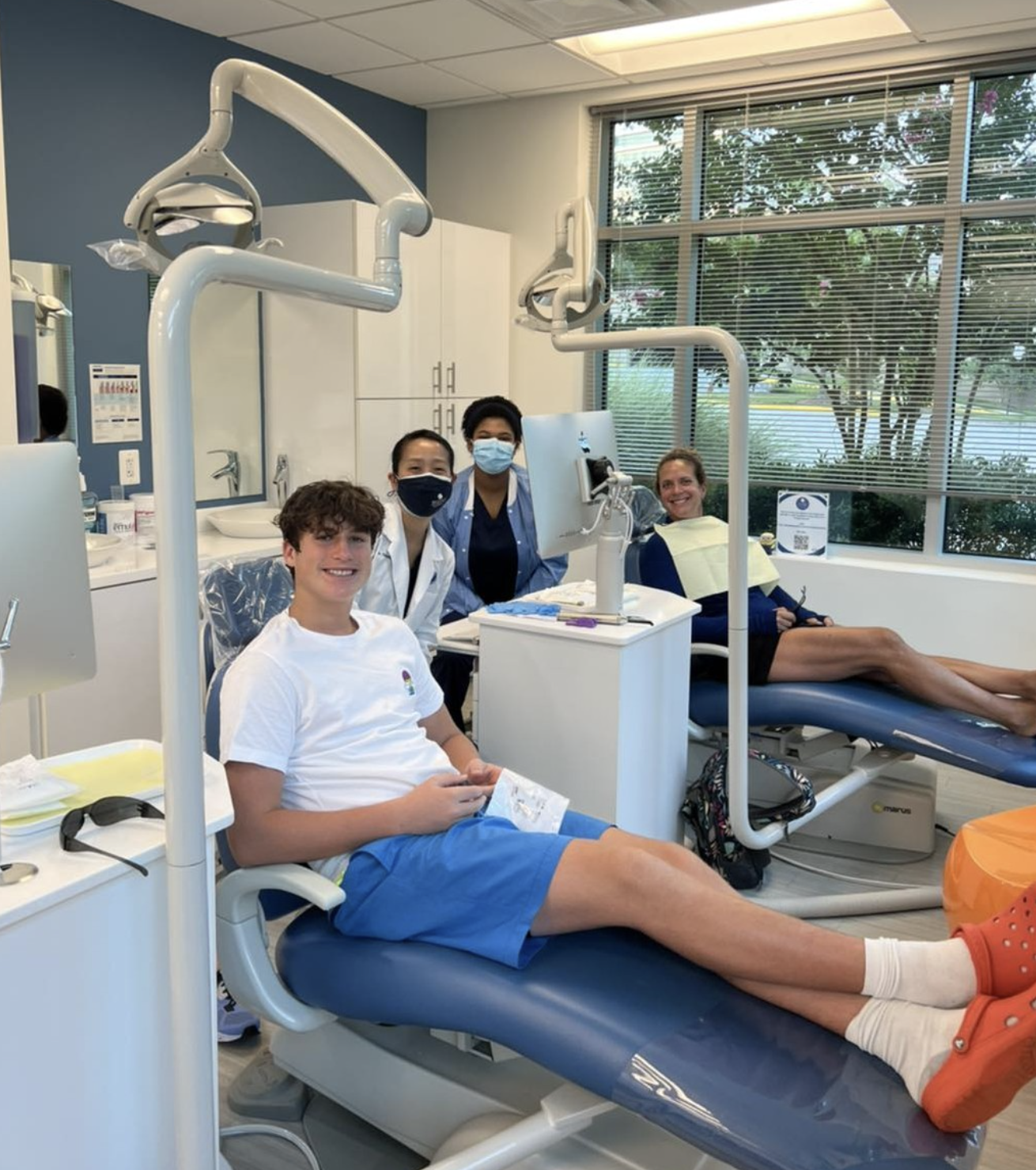 Patients and the Reston Orthodontics team together in the treatment room