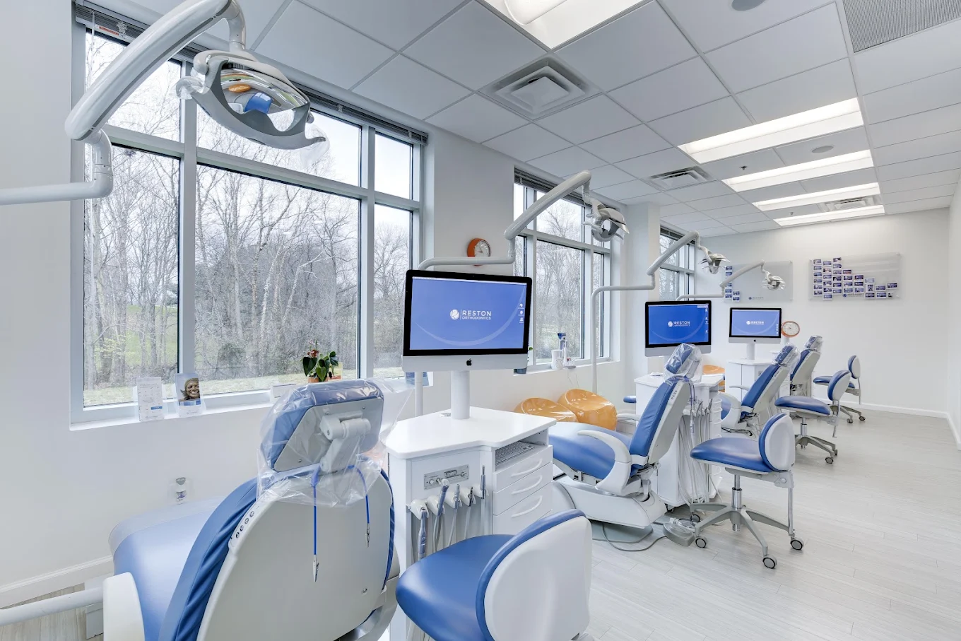 Bright treatment area at Reston Orthodontics with modern dental chairs and large windows